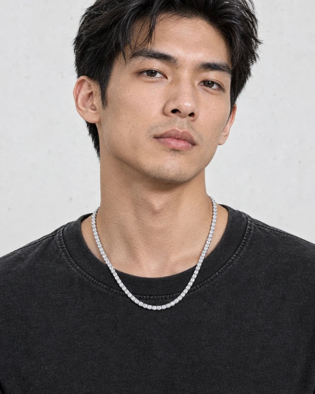 Model wearing the Frost Asia moissanite tennis chain in a white-metal finish