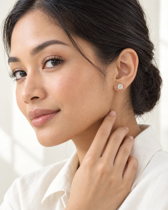 Model wearing the Frost Asia round moissanite stud earring in a yellow-metal finish