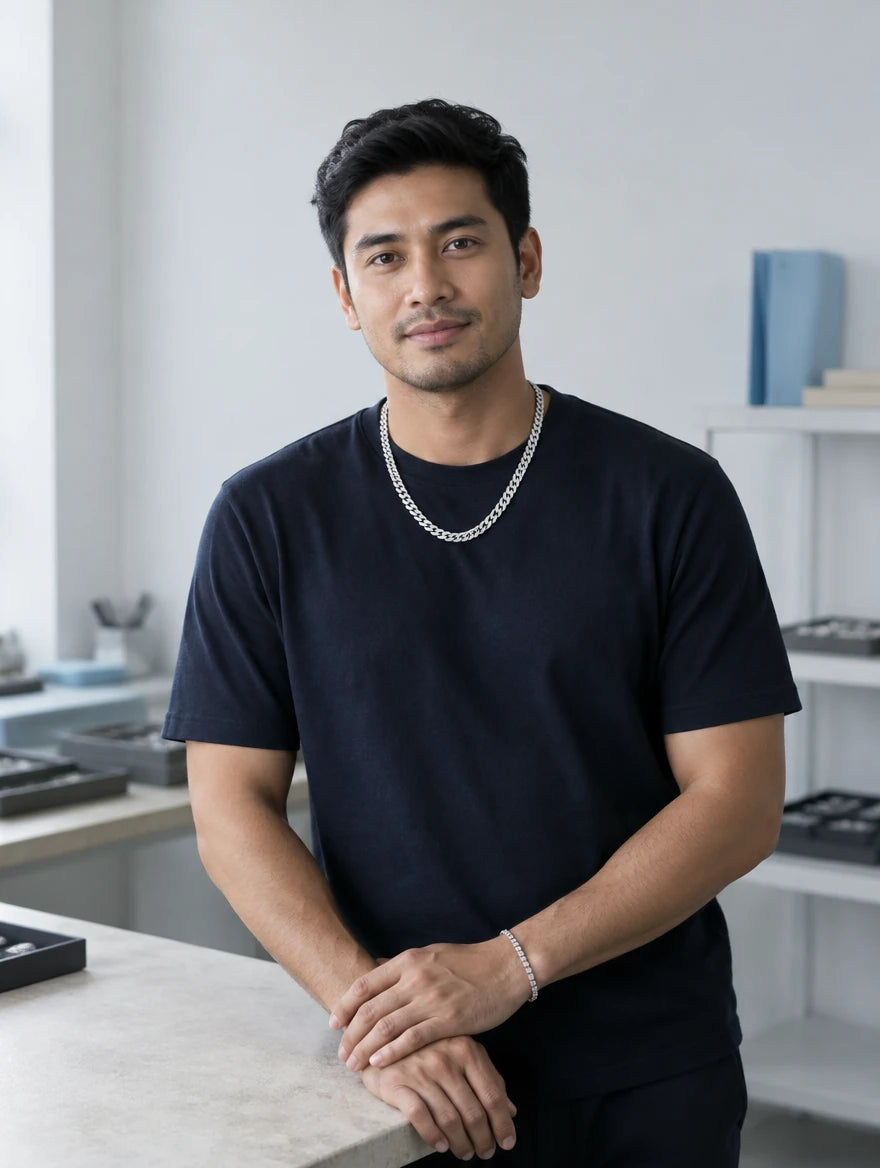 Adrian Tan wearing a silver-tone chain in a bright studio
